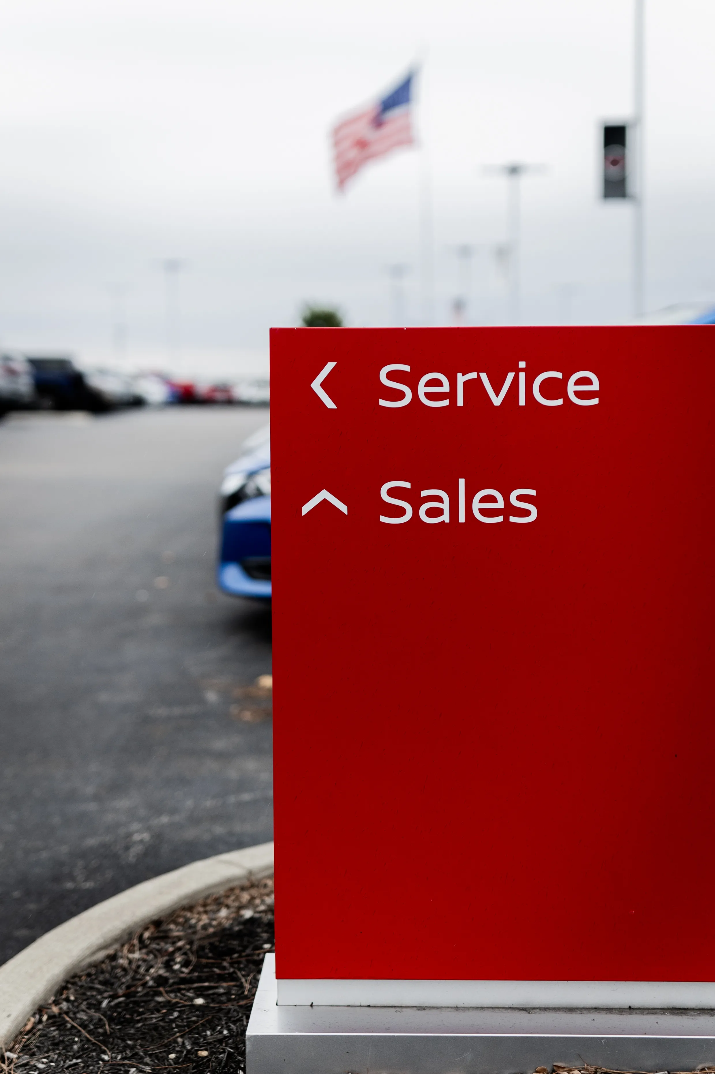 The red directional sign on the Georgesville lot pointing toward Service and Sales
